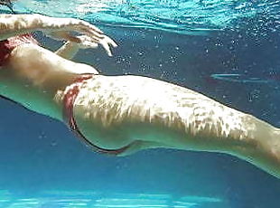 Kittina swims naked in the swimming pool