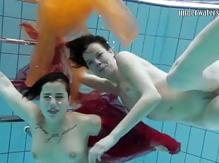 Two hotties submerged underwater