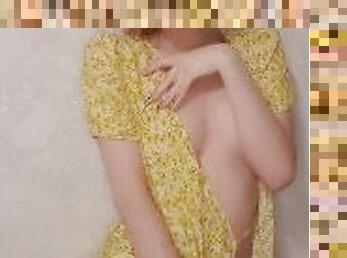 A beauty in a yellow dress poses for the camera and shows off her bubs