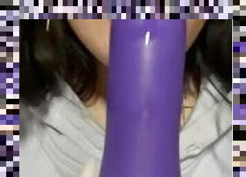 Girl sucks on her purple toy.