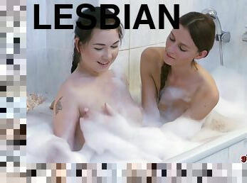 Lesbian girlfriends Daphne and Kira get naughty in the tub.