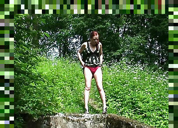 Redhead in red panties pisses outdoors