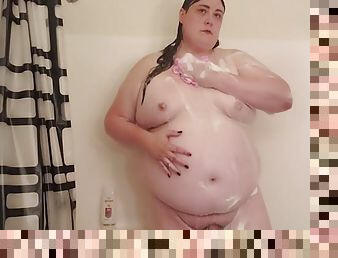 BBW trans Meaghan Jaymes washes her big tits and big ass.