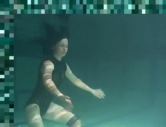Irina Polcharova, shaved brunette, naked in the pool.