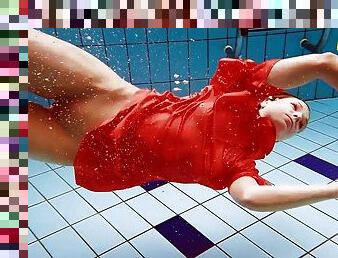 Cute babe in red sexy open dress swimming