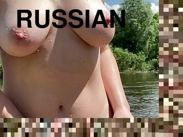 Russian girl bathing naked in countryside river