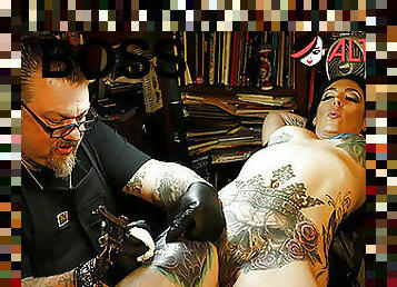 Marie Bossette touches herself while being tattooed