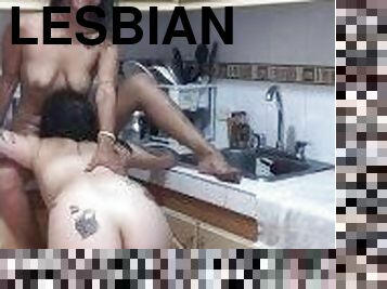 Beautiful tattooed lesbians fuck their pussies in the kitchen