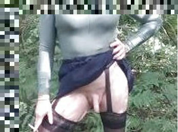 Smoking tranny in the woods showing her small cock