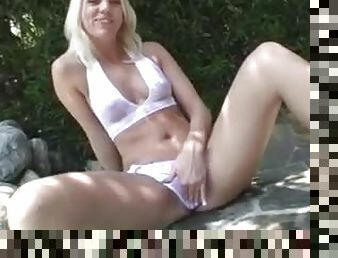 Sexy girl in a white bikini takes a dip