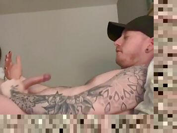 tattooed jock jerks his cock