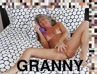 Short granny Leilani Lei spreads her legs to reveal a creamy bald cunt