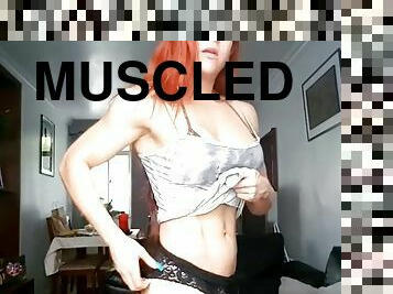 Muscular woman destroys her shirt
