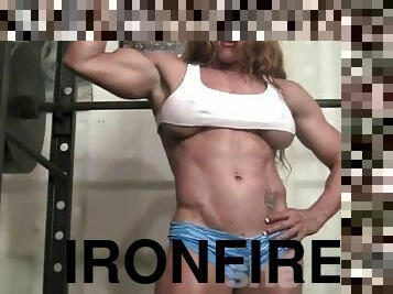 IronFire ripped female bodybuilder works out and poses