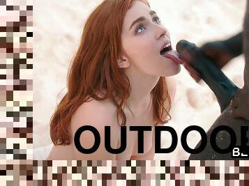 Beautiful redhead Jia Lissa enjoys interracial sex outdoors on the beach