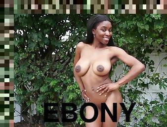 Smiley ebony with big black tits stripping down outdoors