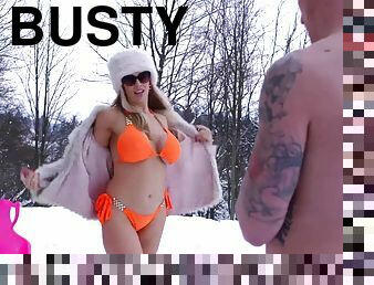 Busty chick gets a winter tan before riding a hard dick