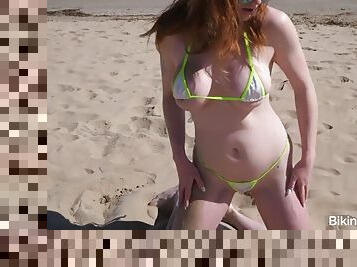 Redhead model in bikini gets naughty in public