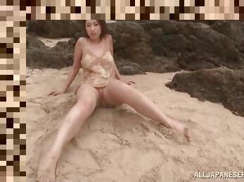 Cute Japanese girl gets sandy on the beach