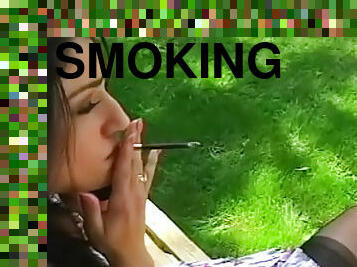 Brunette smoking in a hot sensual way