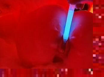 Blue neon enters her pussy, engulfing her in red flames.