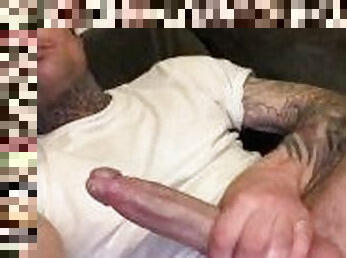 Sexy tatted man jacking off on the couch