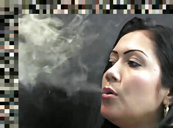 Latina blowing smoke sensually