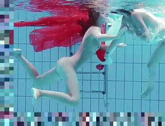 Two lovely girls make angel and demon show underwater