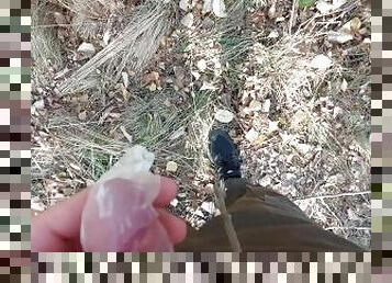 Young horny twink found a used condom in the woods, so he put his cock in it and spermed
