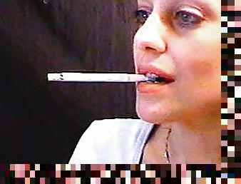 She smokes close up on webcam