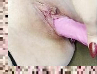 Slut fucks herself with a dildo close up