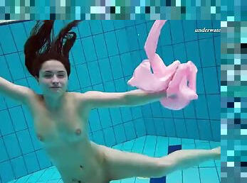 Liza Bubarek, a young girl in a pink swimsuit, undresses underwater.