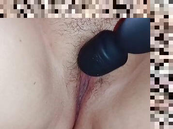 Vibrator on the clitoris. She masturbates her pussy with a vibrator.