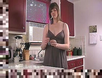 Kinky brown-haired milf smokes and shows her tits in the kitchen