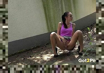 Leggy teen in a miniskirt pees in public