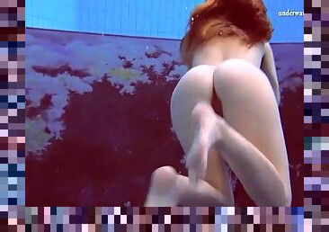 Underwater with a redheaded teen stripping